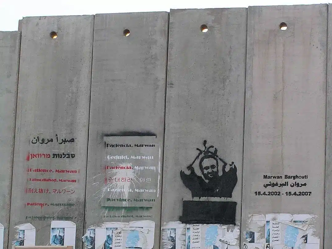 Graffiti supporting imprisoned Palestinian leader Marwan Barghouti on Israel's illegal annexation wall near the Qalandia checkpoint north of Jerusalem. (Eman/Public Domain)