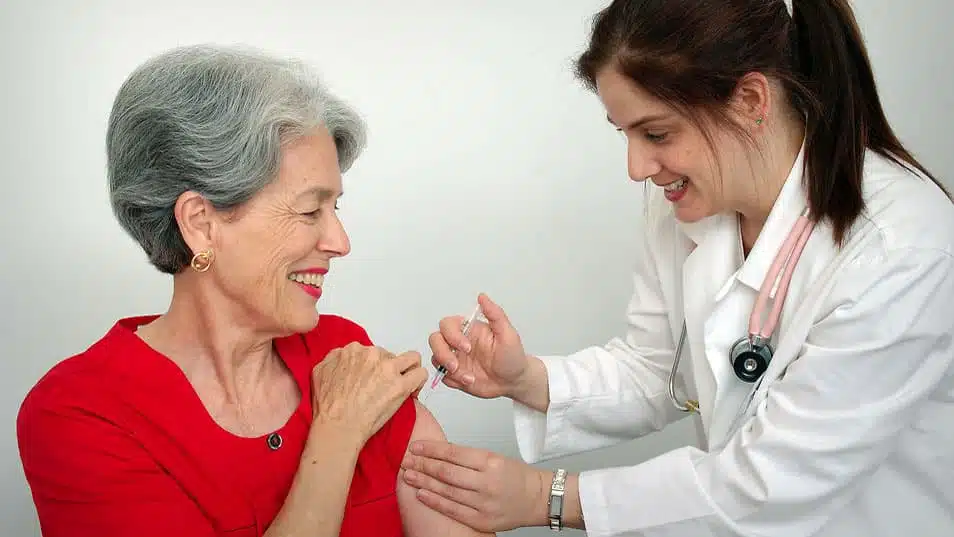 A senior woman receiving a vaccination from her doctor. (CDC/Public Domain)