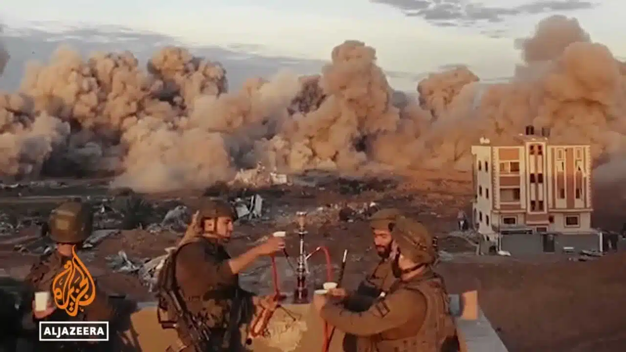 Israeli soldiers celebrate the wanton destruction of a neighborhood in Gaza.